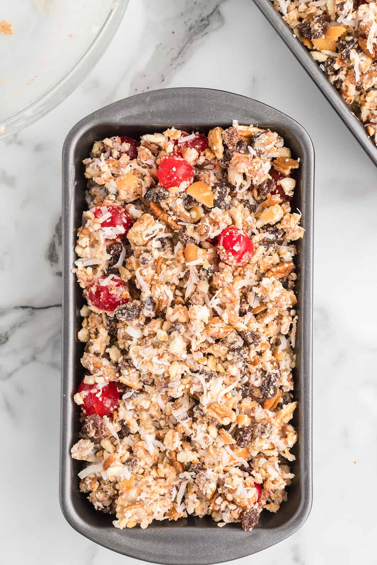 Fruitcake mixture packed into a loaf pan.