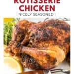 Seasoned rotisserie chicken on a platter with lemon slices, herbs, and serving utensils nearby.