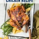 Rotisserie chicken on a tray with lemon wedges, herbs, and cutlery; text: Air Fryer Rotisserie Chicken Recipe.