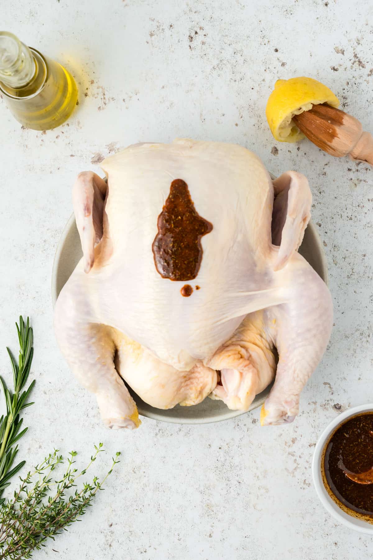 Applying seasoning rub to the chicken.