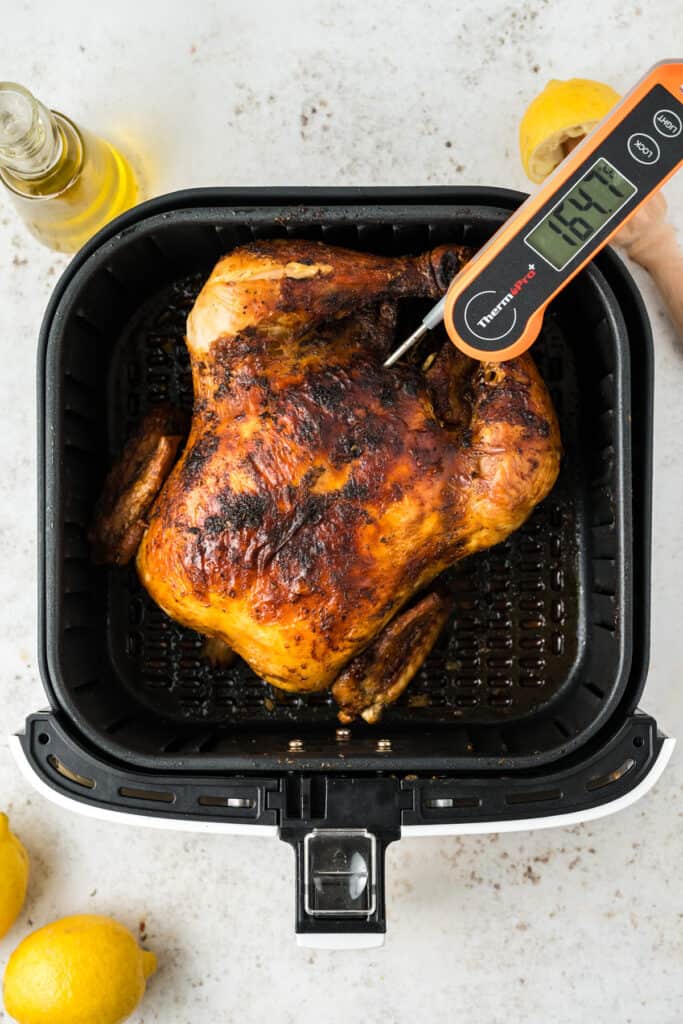 Checking the internal temperature with a meat thermometer.