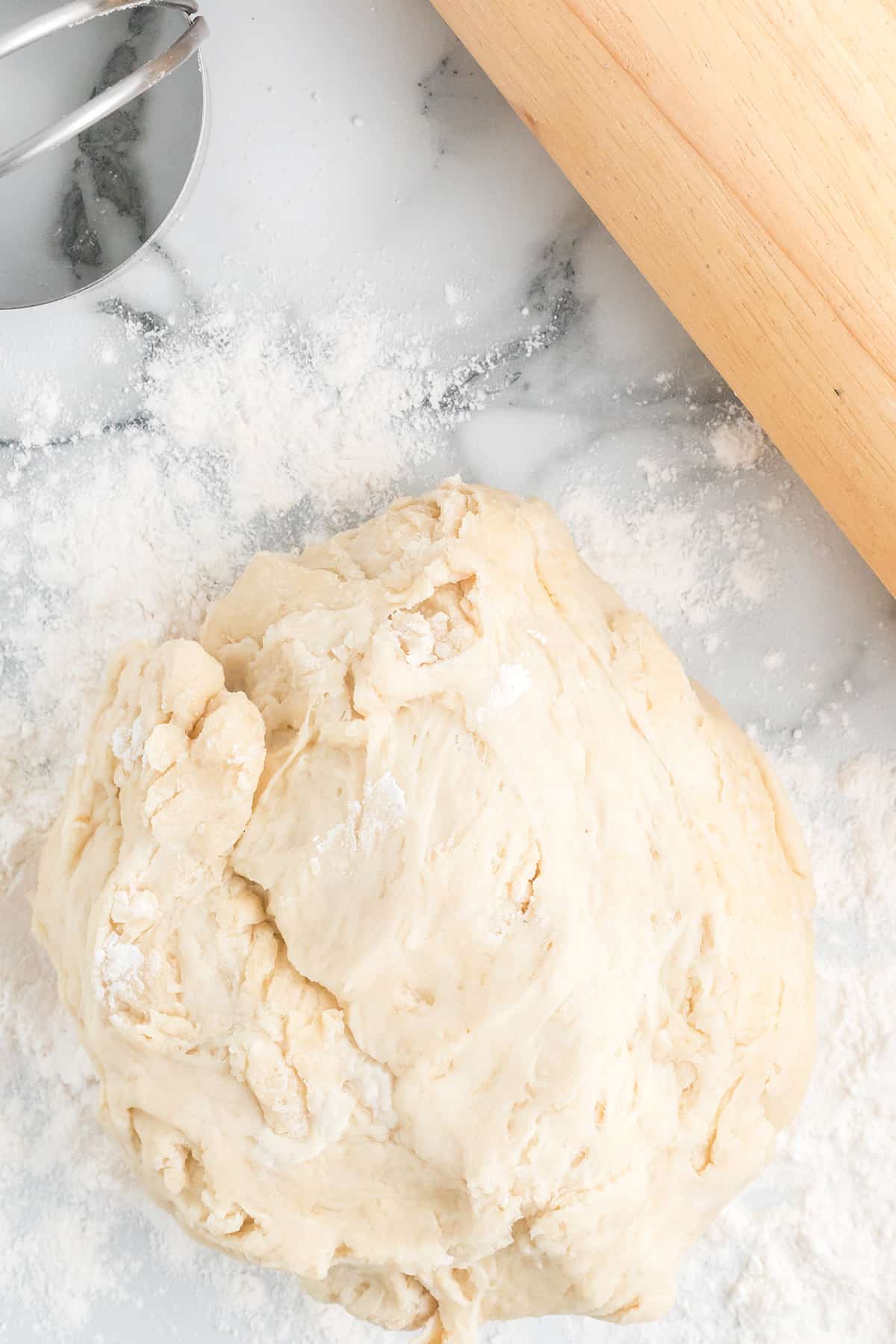 Dough in a mound on a marble background.