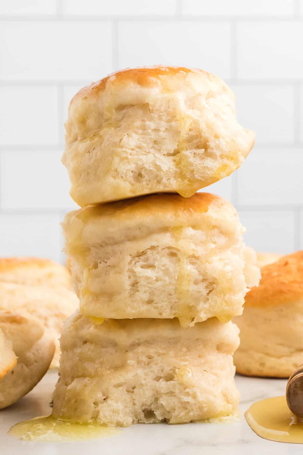 A stack of biscuits dripping with honey.