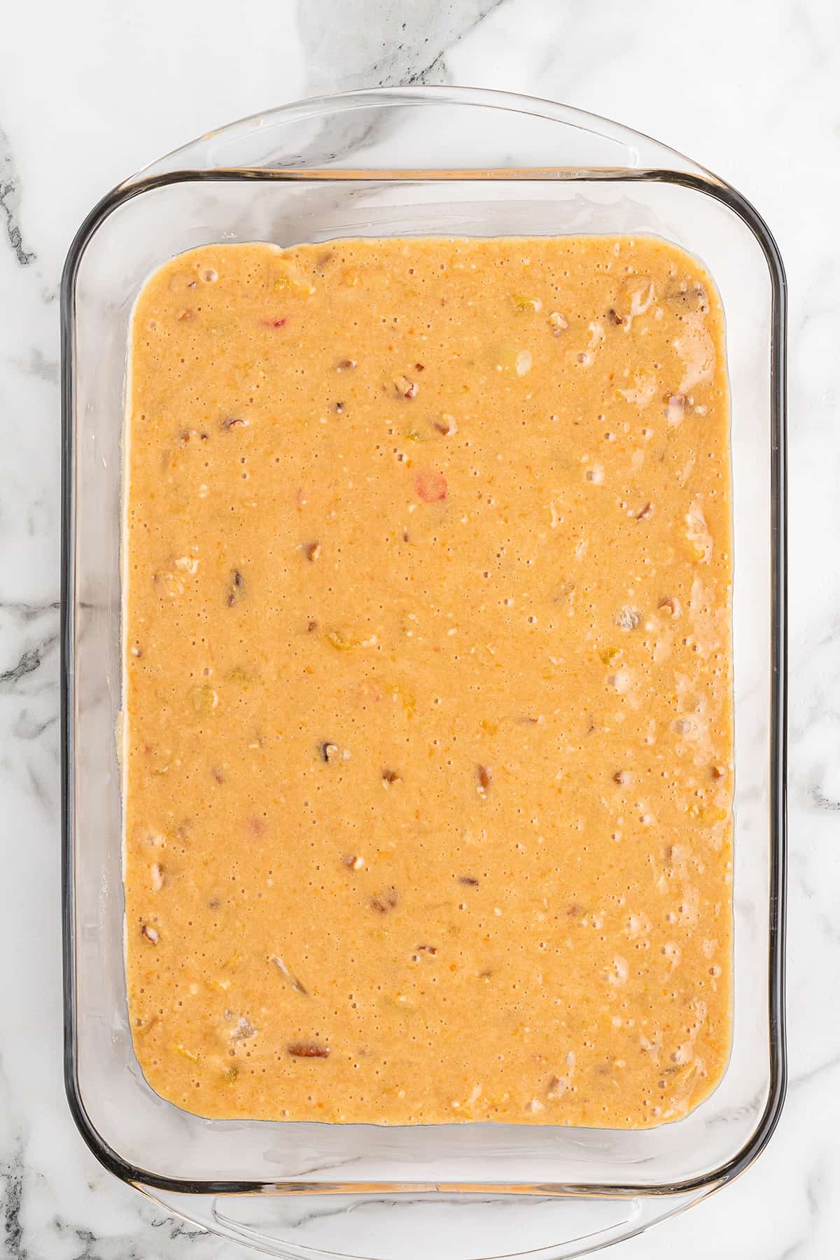 Cake batter in a 9x13 baking dish.