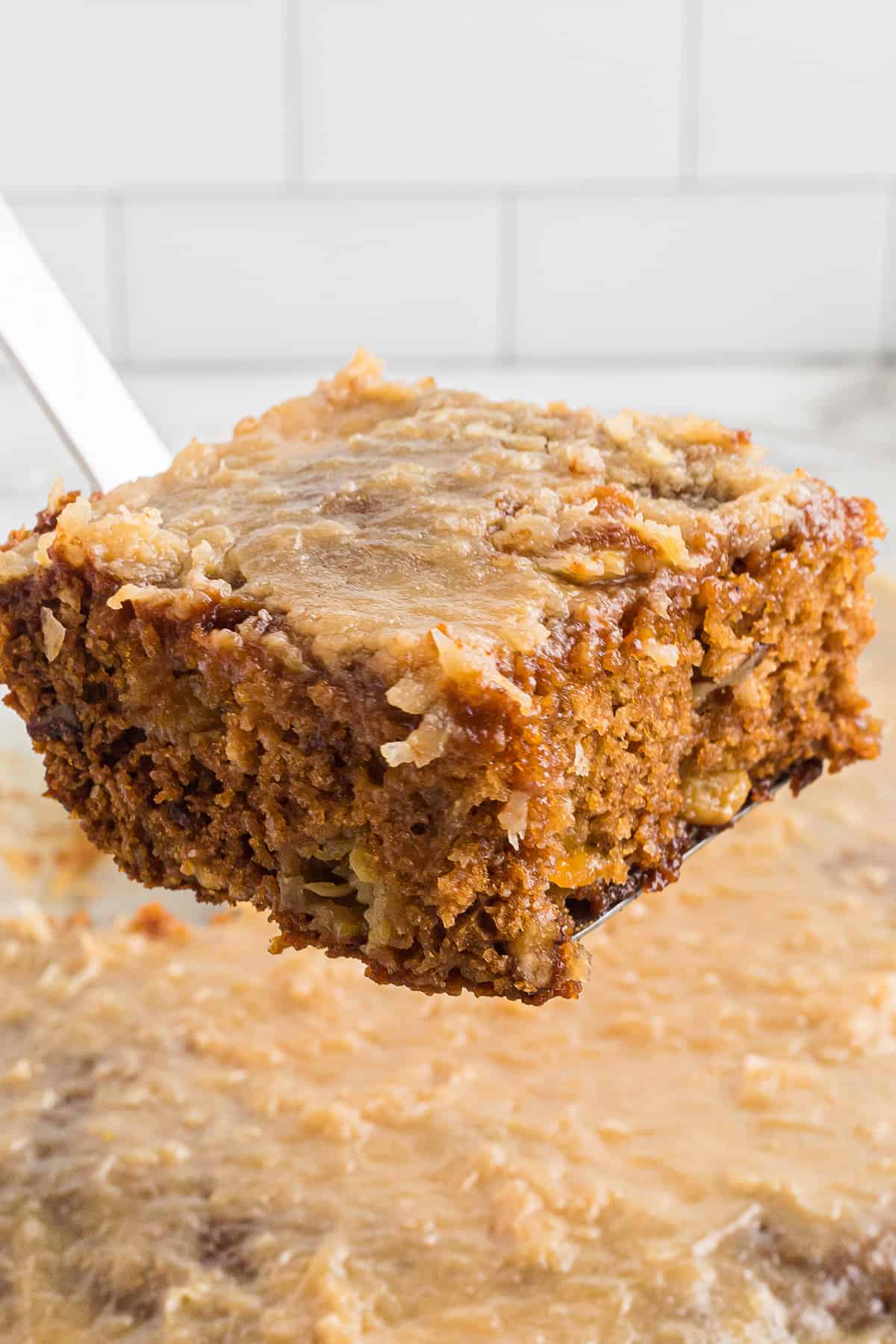 A slice of cake held on a spatula.