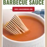 A white ramekin of barbecue sauce with a brush, labeled Homemade Barbecue Sauce at the top.