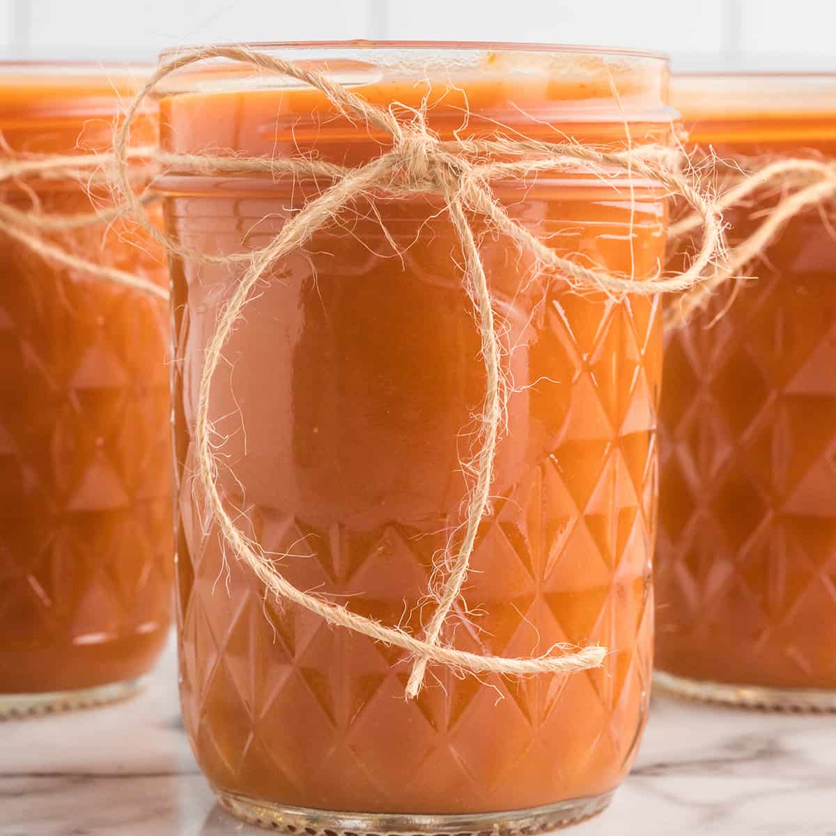 Finished barbecue sauce in small jars.