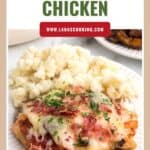 A plate of bistro chicken topped with cheese and bacon, served with a side of mashed potatoes.