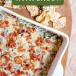 A baking dish of turnip green dip with bacon, served with tortilla chips on a wooden board.