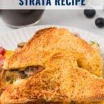 A slice of ham and cheese strata on a white plate with a coffee cup and blueberries in the background.