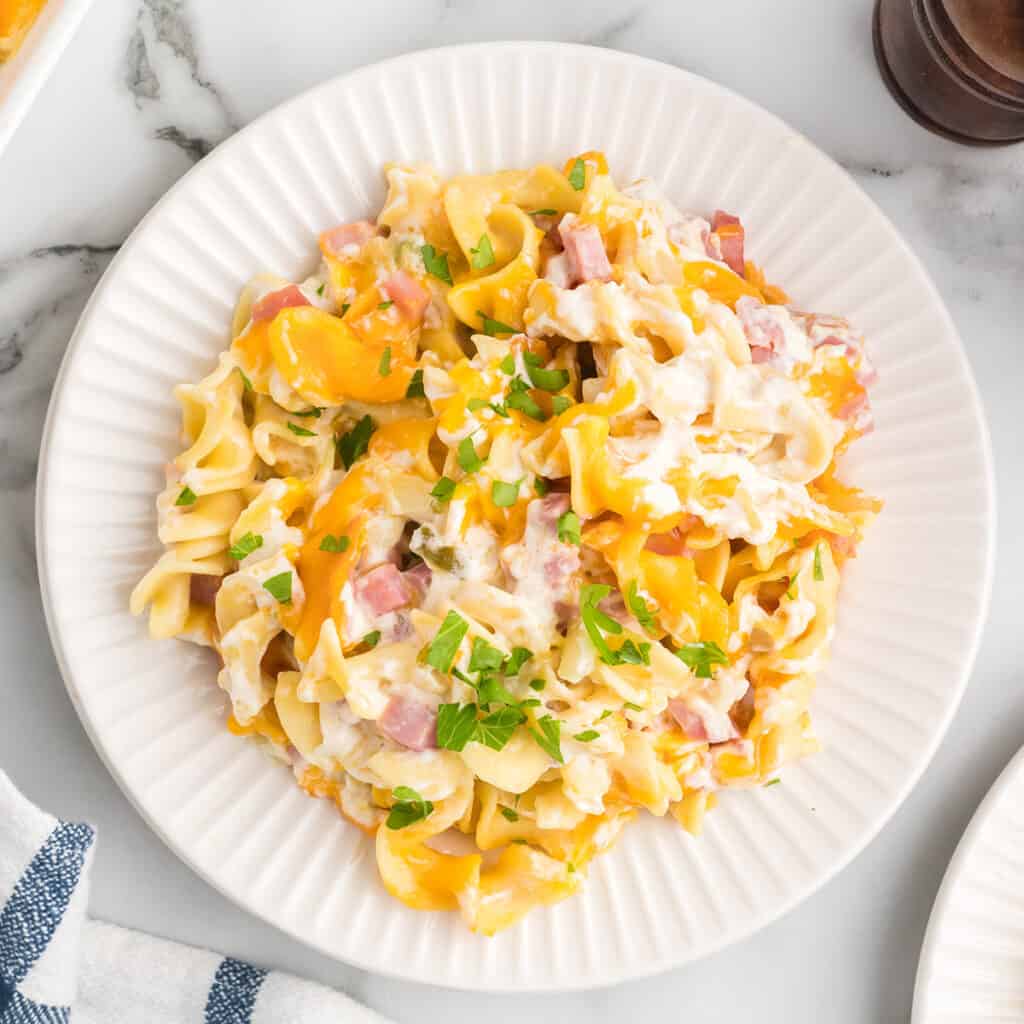 A serving of ham casserole on a white plate.