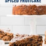 A sliced traditional Irish spiced fruitcake on a white cake stand, with pieces served on plates.