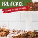 A slice of traditional Irish spiced fruitcake dusted with powdered sugar on a white plate.