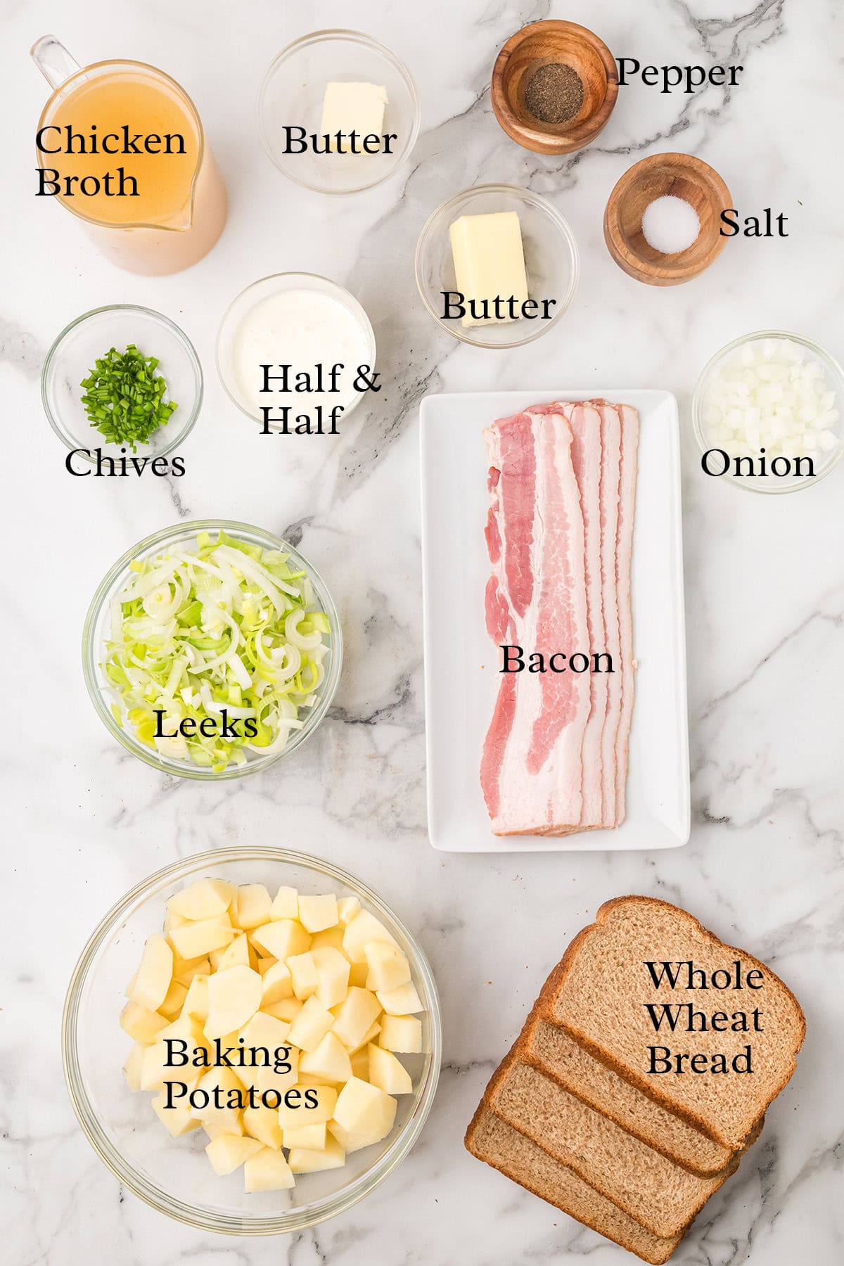 Ingredients for leek and potato soup, including bacon, potatoes, leeks, onion, broth, butter, bread, and seasonings.