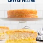 A slice of lemon cheese-filled cake on a plate, with a whole cake in the background.