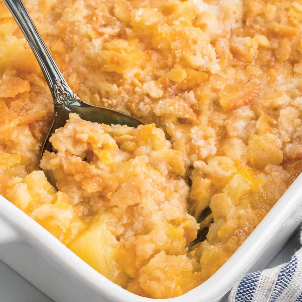 Casserole with a serving spoon dipping into the contents.