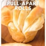 Golden brown homemade pull-apart rolls, freshly baked, shown close-up on a wooden surface.