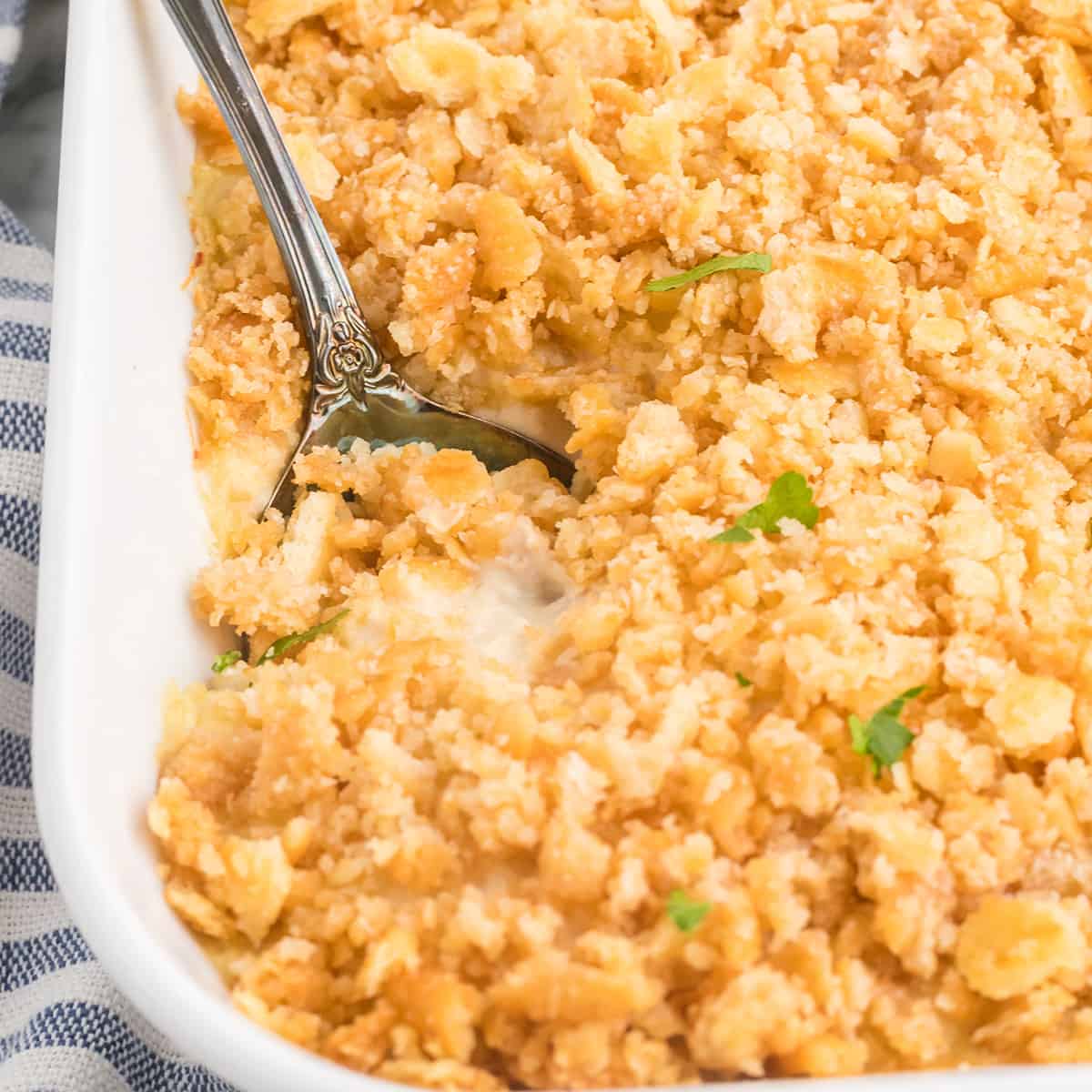 Casserole with a serving spoon in a dish.