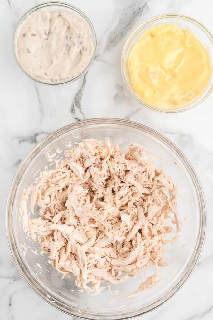 Chicken meat in a mixing bowl.