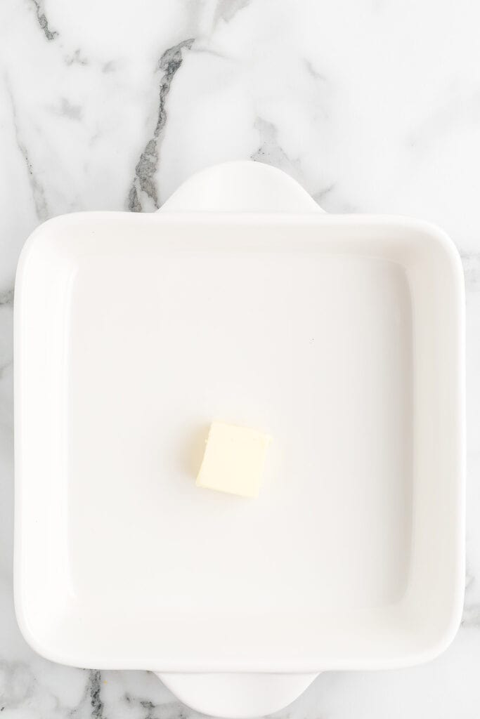 Butter in a baking dish.