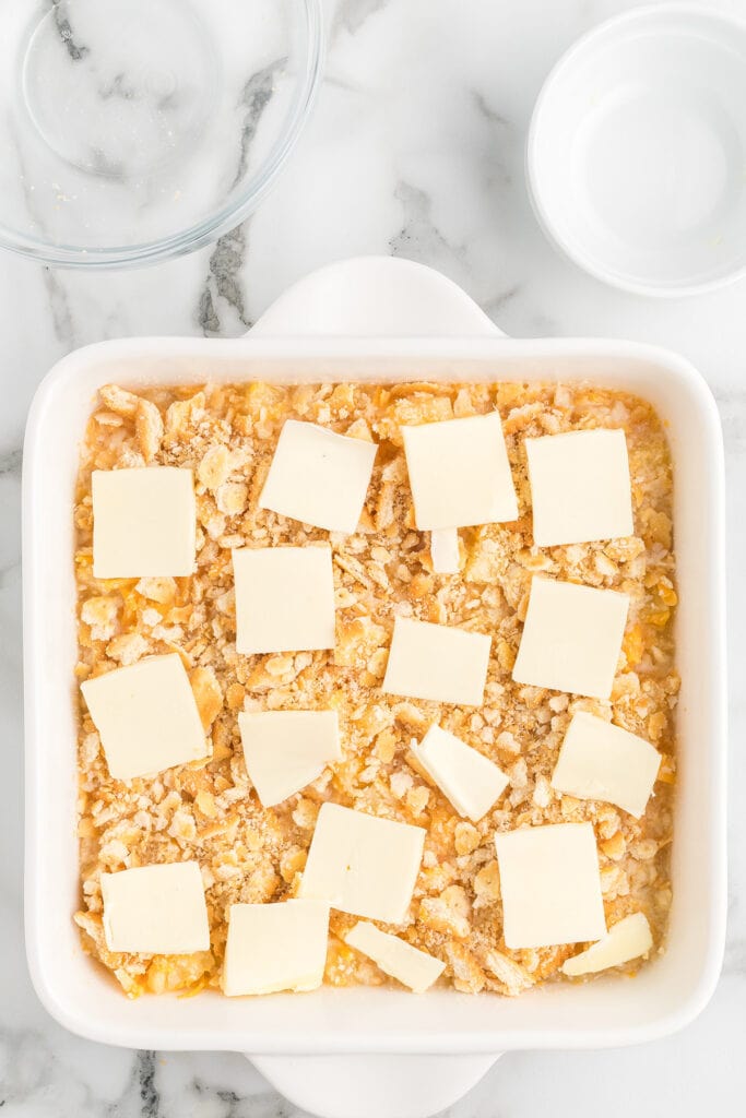 Butter added to top of cracker crumbs.