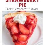 A slice of fresh strawberry pie with whipped cream on top, served on a white plate.