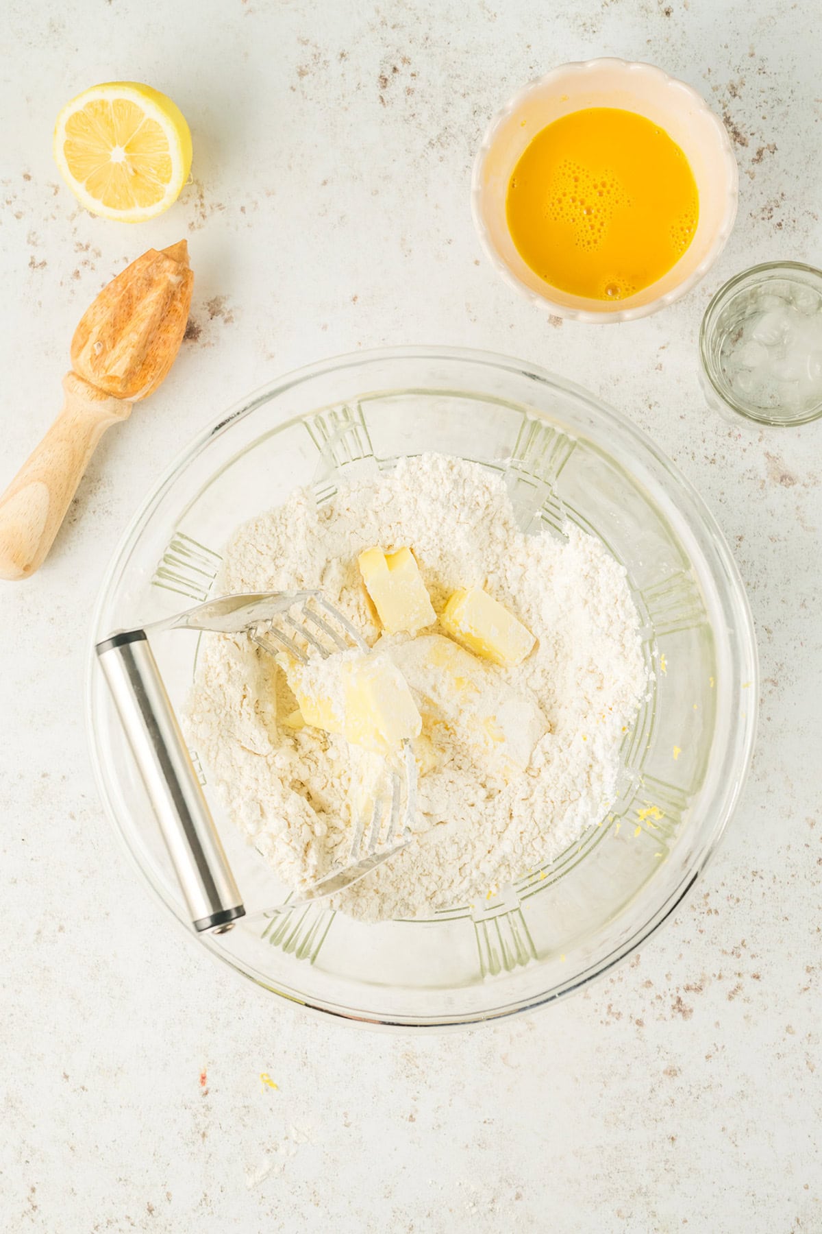 Cutting in butter with a pastry blender.