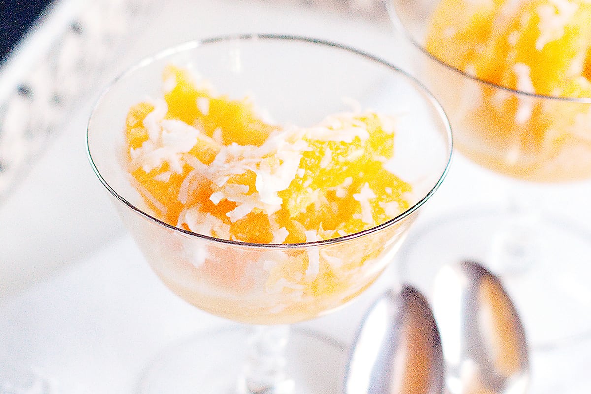 A serving of ambrosia in a crystal sherbet dish.