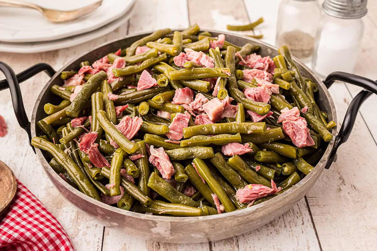 A pan filled with cooked green beans.