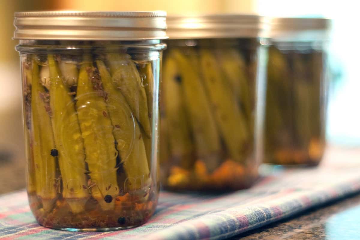 Three jars of pickled okra.