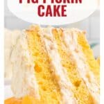 A slice of yellow layer cake with creamy frosting and an orange slice, labeled Pig Pickin Cake.
