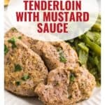 Sliced pork tenderloin with mustard sauce, served with green beans on a white plate.
