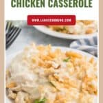 A plate of Ritz cracker chicken casserole garnished with parsley, with a fork and napkin beside it.