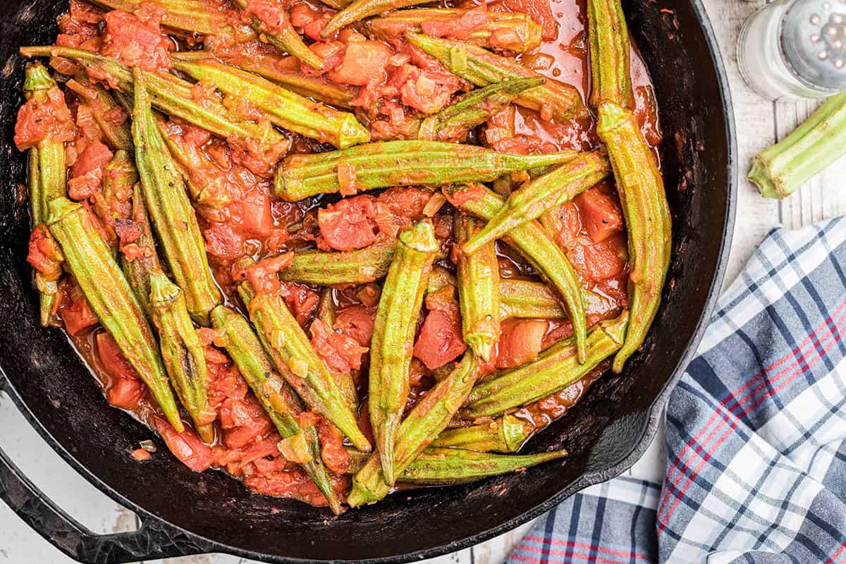 Stewed okra and tomatoes in a black cast iron skillet.