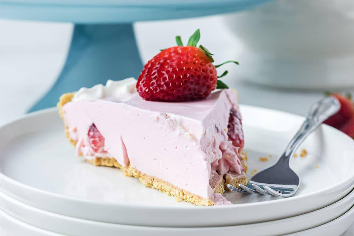 A slice of strawberry jello pie on a serving plate.