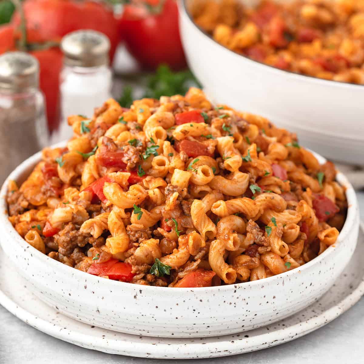 A white bowl filled with American goulash.