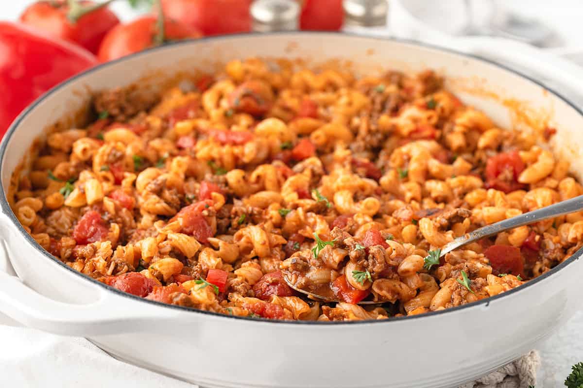 A white bowl filled with American goulash.
