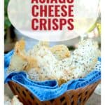 A basket of asiago cheese crisps on a blue napkin, with wine glasses and greenery in the background.