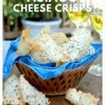 A basket of Asiago cheese crisps on a blue napkin, with two glasses of white wine in the background.