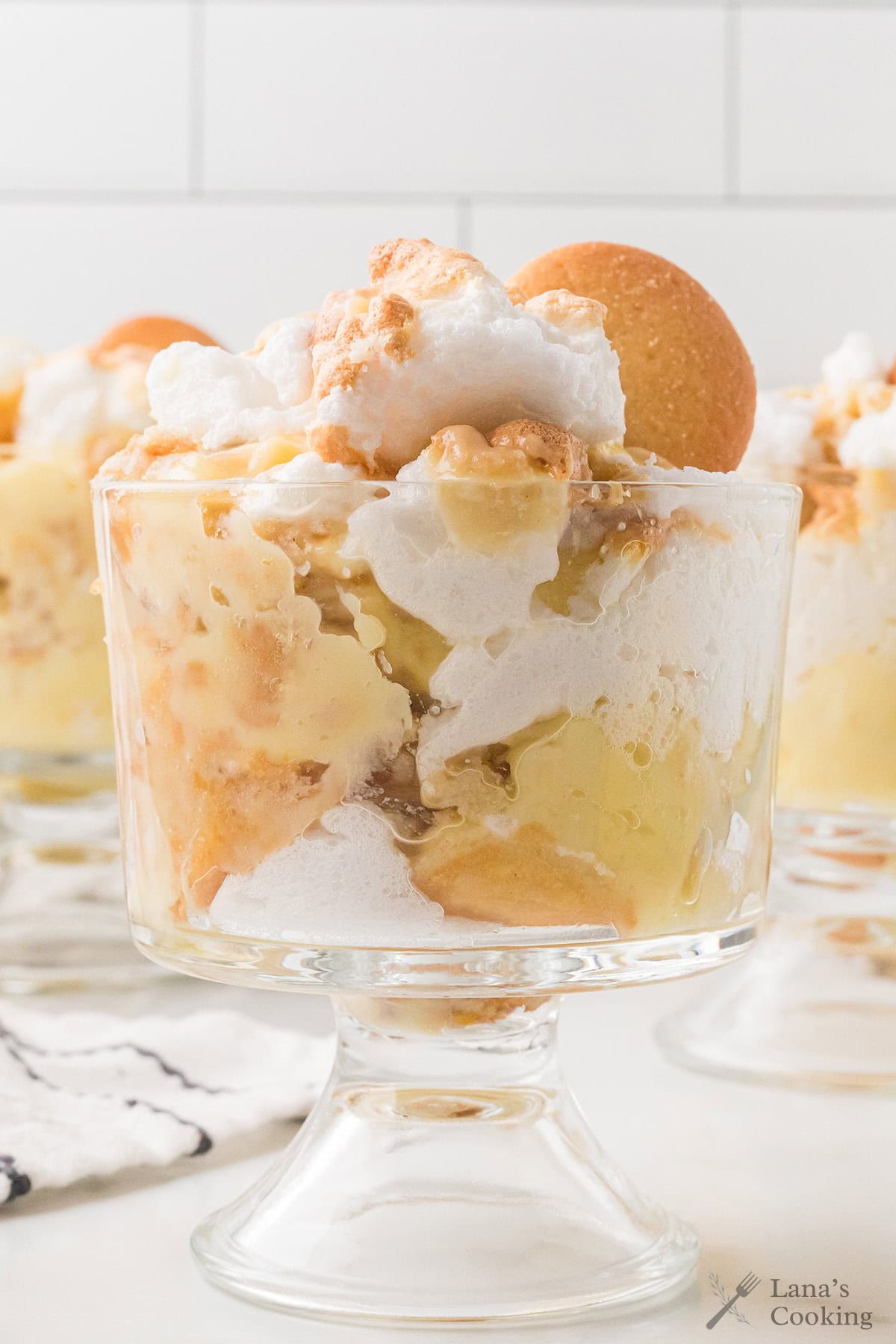 A serving of banana pudding in a clear glass dish.