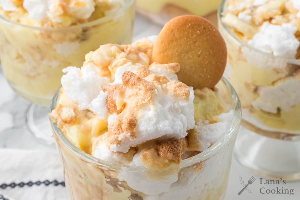 A serving of banana pudding in a clear glass dish.