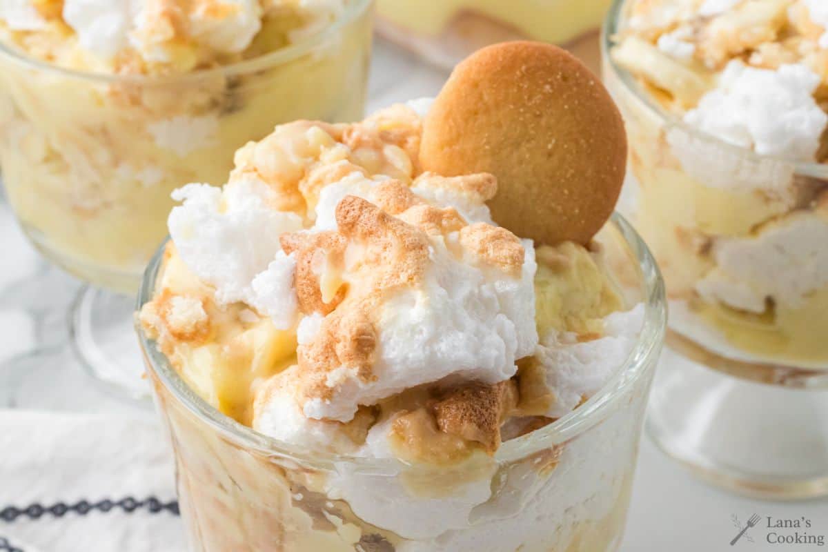 southern banana pudding in a glass serving dish with a vanilla cookie on top