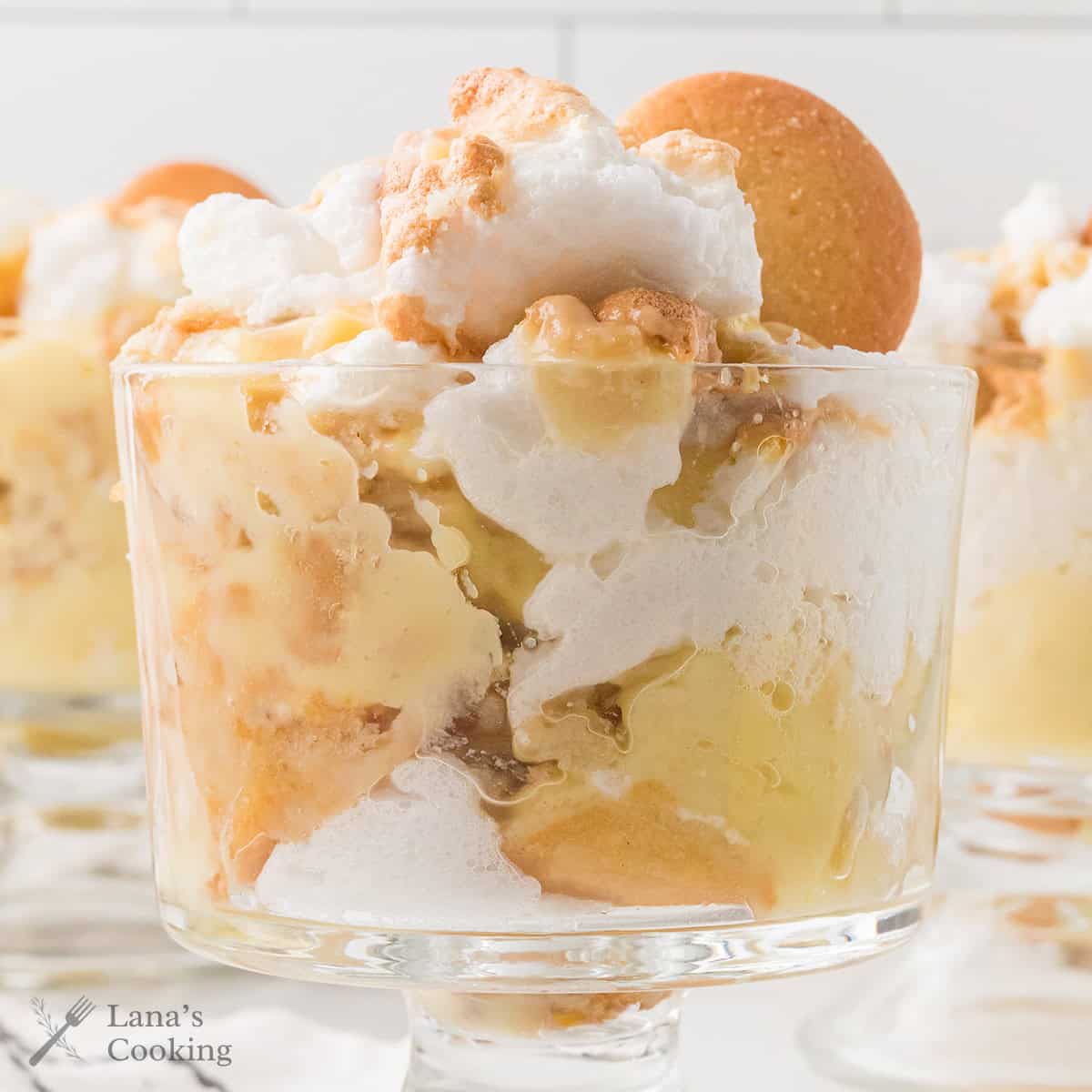 A serving of banana pudding in a clear glass dish.