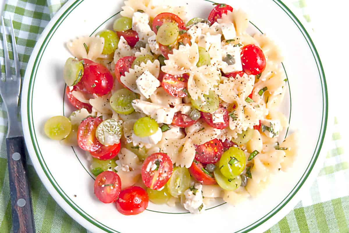 A serving of Bowtie Pasta Salad with Grapes in a bowl.