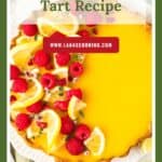 Lemon tart topped with fresh raspberries and lemon slices, with Lemon Raspberry Tart Recipe text above.