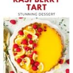 A lemon raspberry tart garnished with lemon slices and raspberries on a white plate, viewed from above.