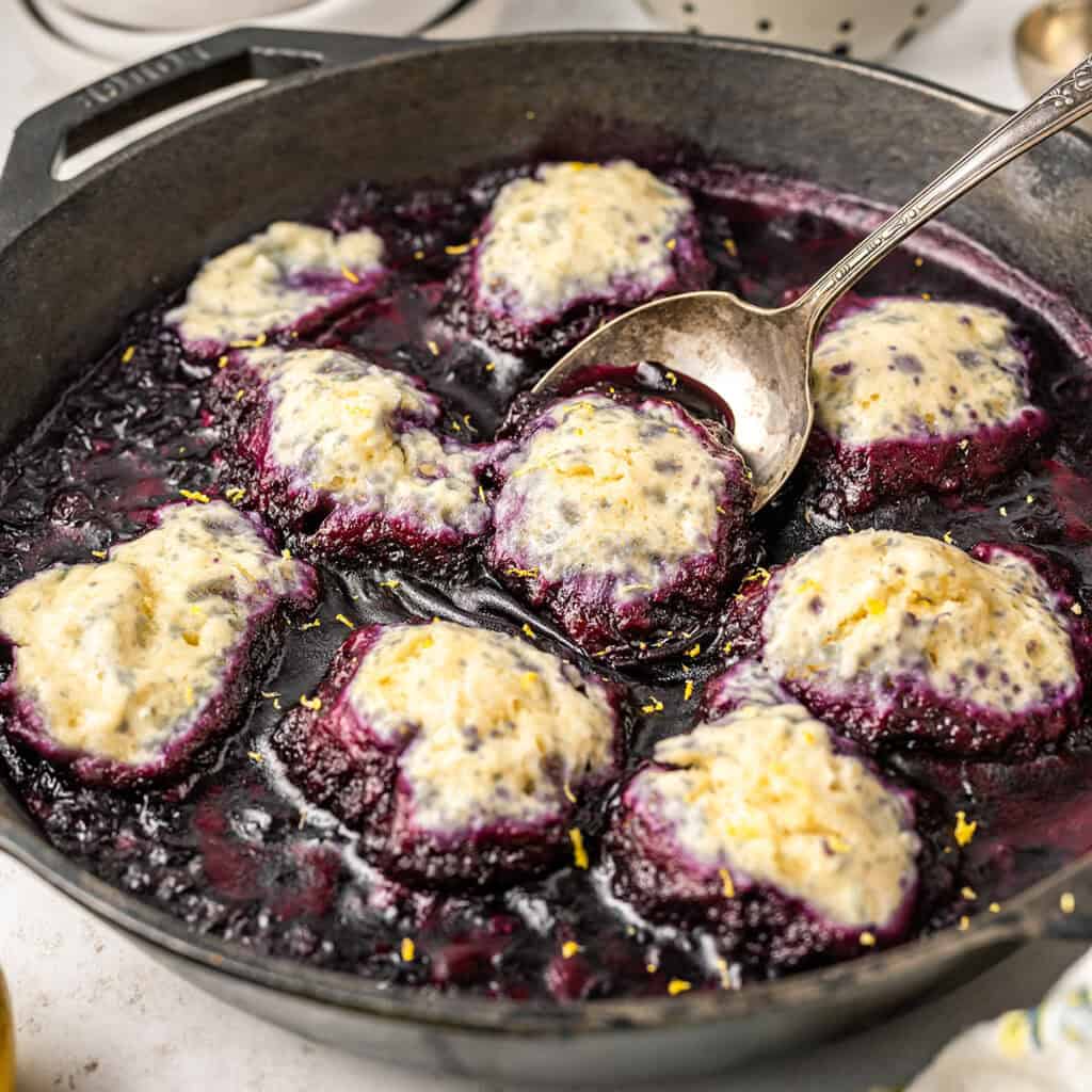 Finished blueberry slump in a black cast iron skillet.