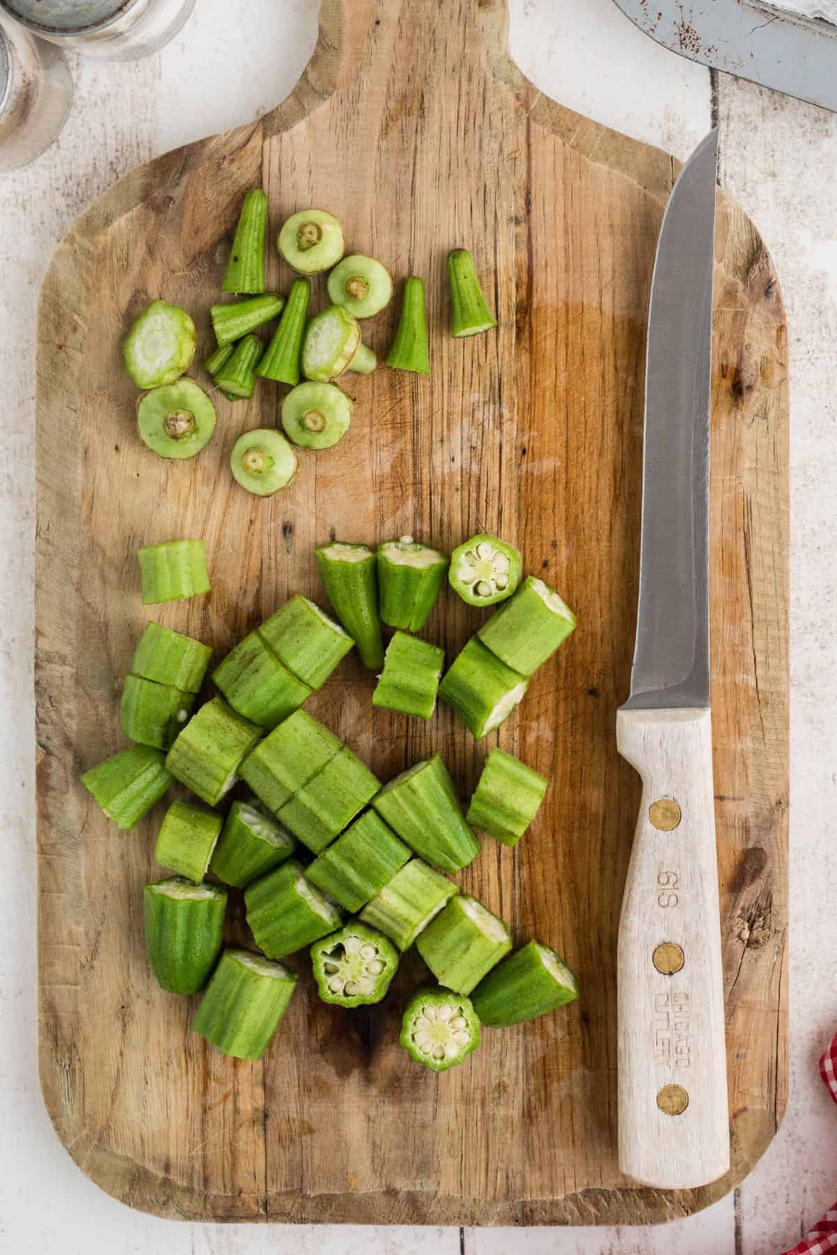 Cut okra on a wooden board.