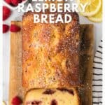 Sliced lemon raspberry bread on a wooden board with raspberries and lemon slices nearby.