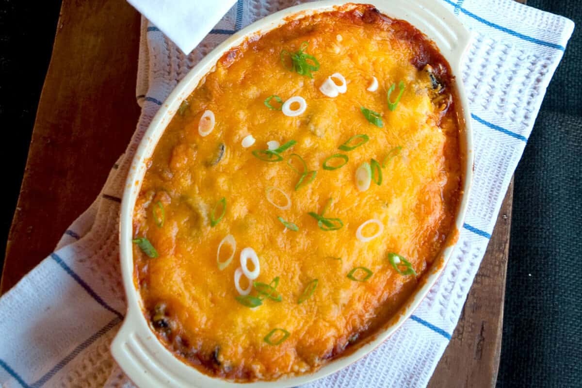 Baked refried bean dip in a baking dish.